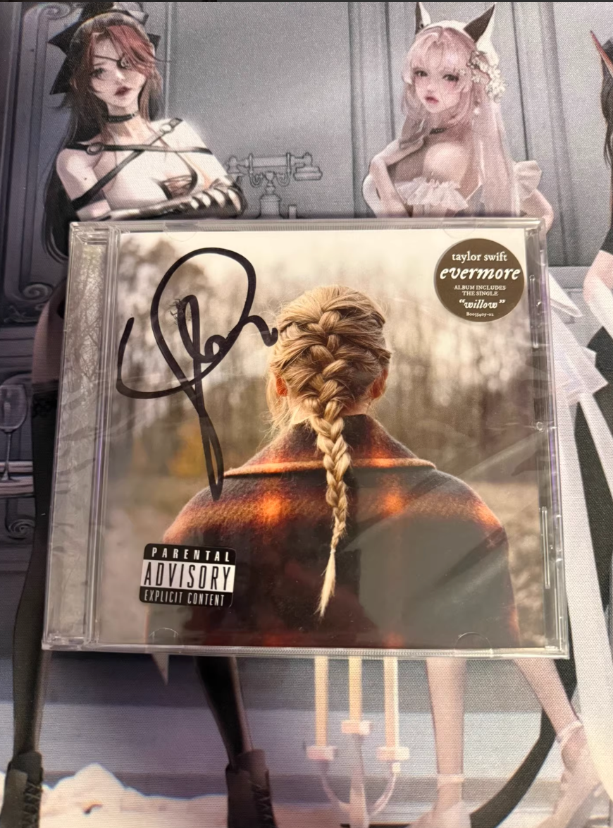 Taylor Swift *evermore* signed CD (sealed, standard “chicken leg” signature)
