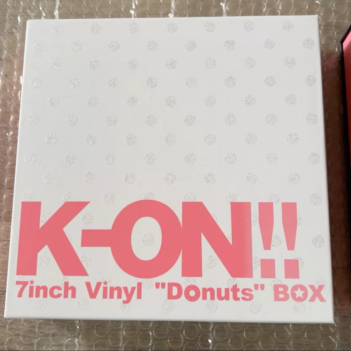 K-ON!! *Donuts* 7-inch vinyl box set, black box sealed, white box opened once, with minor outer wear.