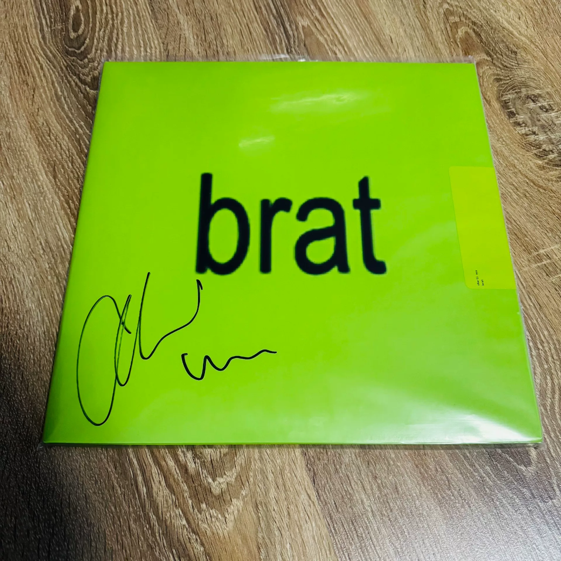 Charli XCX *Brat* signed black vinyl LP. Signature on outer sleeve (not a card). Factory sealed with shrink partially opened for autograph. Minor handling traces, overall excellent.